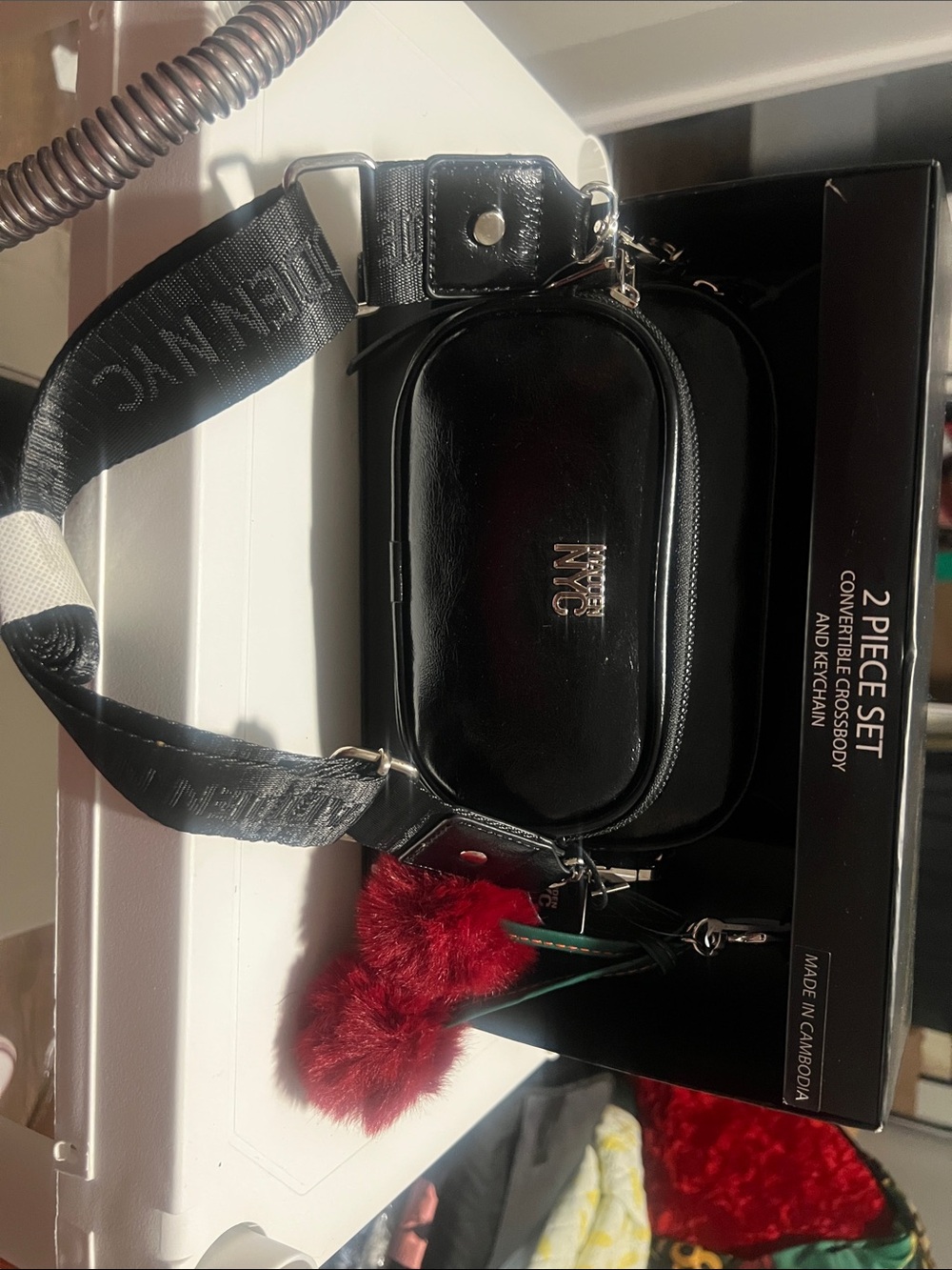 NYC Black Crossbody Bag with Red Pom Charm